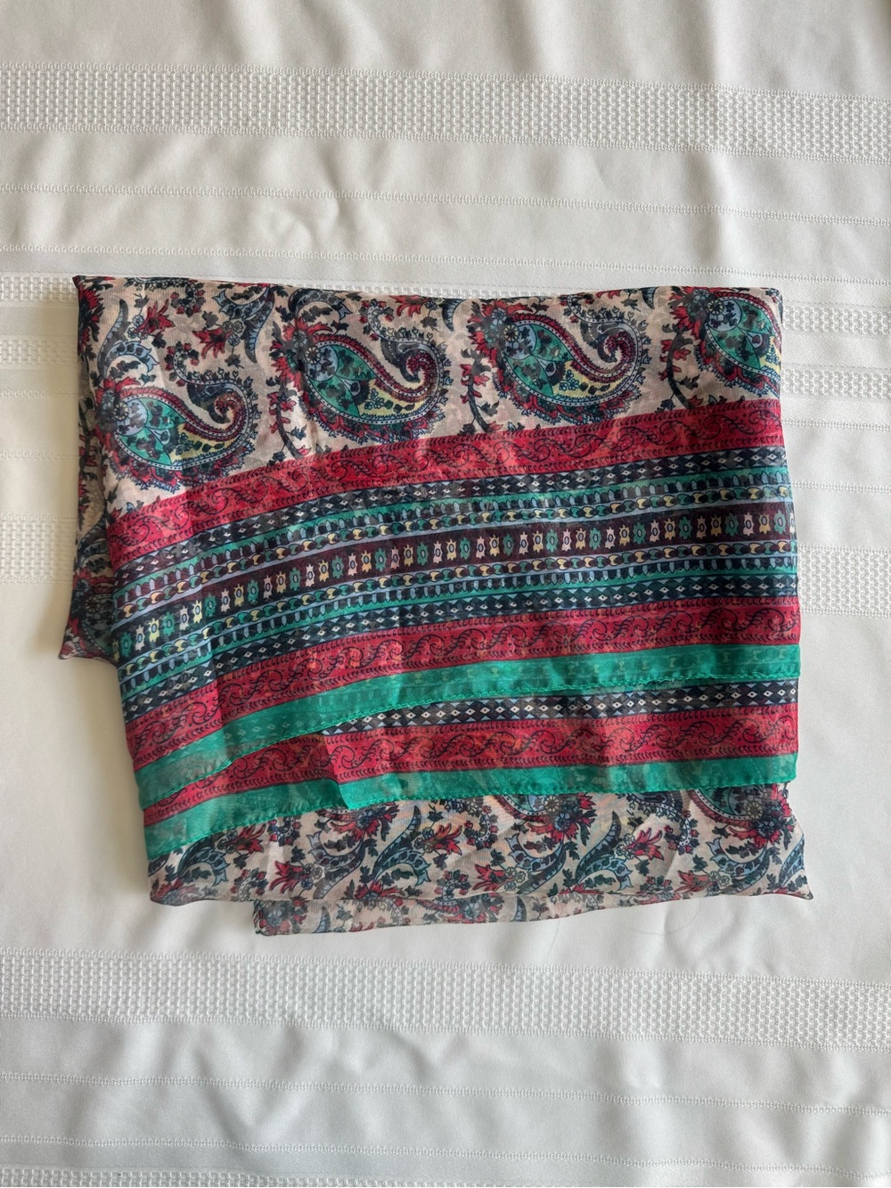 A lightweight, semi-sheer scarf adorned with a paisley pattern (43 x 76 inches)